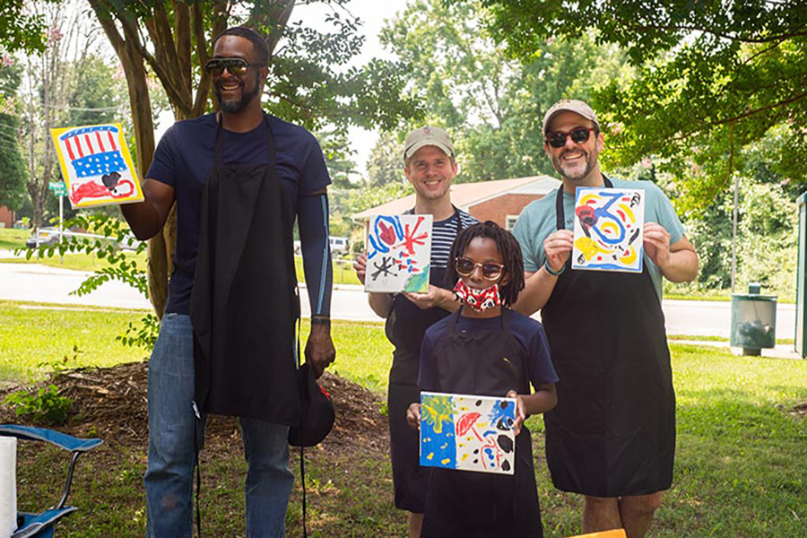 Four adults and a child present their artwork.